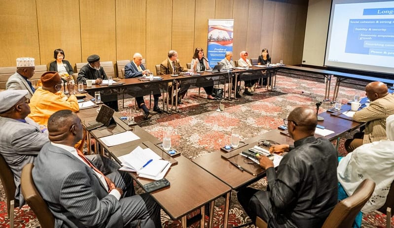 A religious freedom roundtable: A gathering of individuals, assembled in a conference room, engaging in discussions around a table.